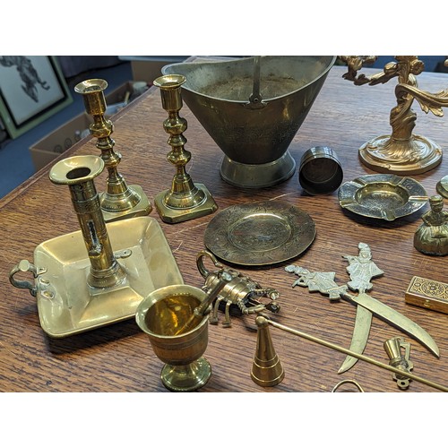 494 - Mixed brass and metalware items to include candle sticks, trophy, floral design photo frame, candle ... 