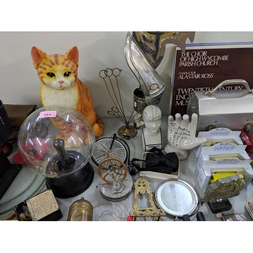 284 - A mixed lot to include a model cat, a plasma ball, an Avominor, a china model of a hand and head, an... 