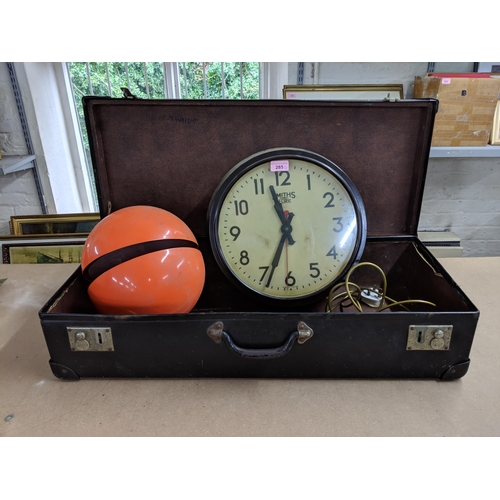 285 - A leather bound case, along with a reproduction electric Smiths clock and an orange circular retro l... 