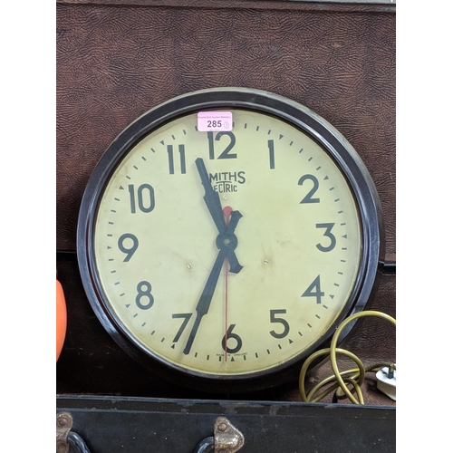 285 - A leather bound case, along with a reproduction electric Smiths clock and an orange circular retro l... 