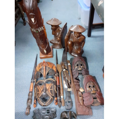 388 - A quantity of African treen to include two carved busts together with a butterfly wing tray and Asia... 