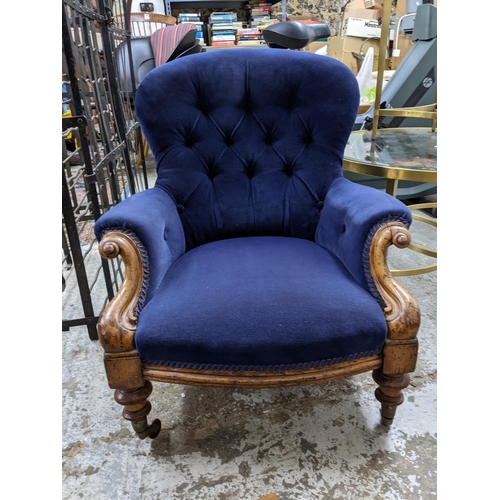 393 - A Victorian walnut framed upholstered nursing chair, blue button back upholstery, turned front legs ... 