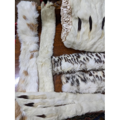 394 - A Victorian ermine hand muff and matching ermine shoulder wrap, another fur hand muff, and other fur... 