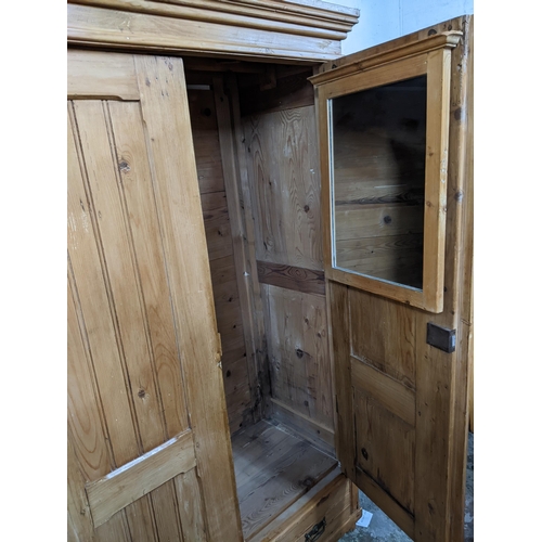 427 - A Victorian pine twin door wardrobe, stepped cornice above twin panel fielded doors, above a base dr... 