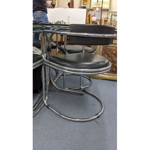 470 - A mid 20th century smoked glass topped dining table, together with four matching leather and chrome ... 