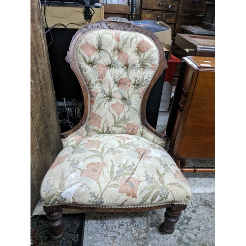 503 - A Victorian mahogany upholstered nursing chair with carved decoration and turned front legs Location... 