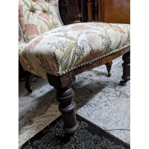 503 - A Victorian mahogany upholstered nursing chair with carved decoration and turned front legs Location... 