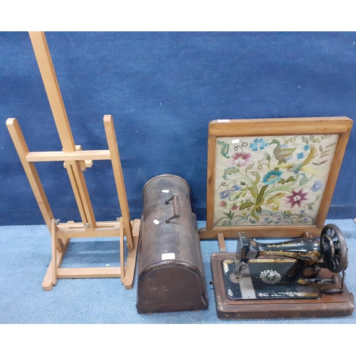 510 - A Singer sewing machine in domed oak case, an oak framed tapestry fire screen, a pine easel
Location... 