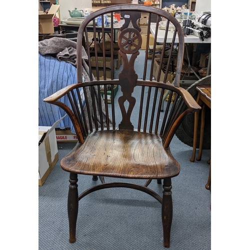 516 - A 19th century yew, ash and elm, Windsor armchair having a pierced splat back with spindle supports ... 