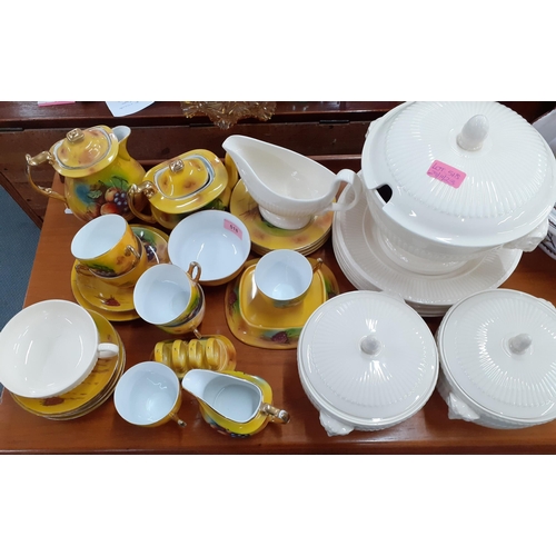 518 - A Phoenix china yellow ground tea and breakfast service decorated with images of fruit together with... 