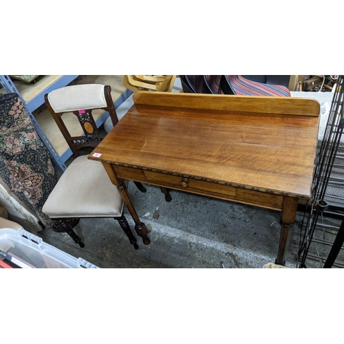 395 - An early 20th century oak side table with extended back, a single frieze drawer on octagonal turned ... 