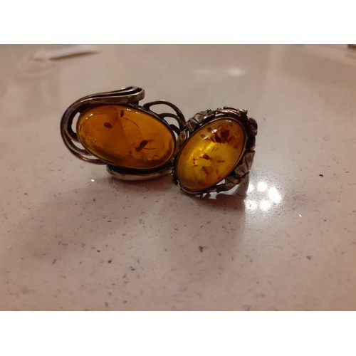 62 - Two silver and amber Modernist rings, a silver marcasite ring, a silver pendant with micro-mosaic in... 