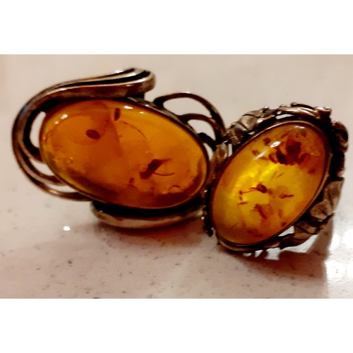 62 - Two silver and amber Modernist rings, a silver marcasite ring, a silver pendant with micro-mosaic in... 