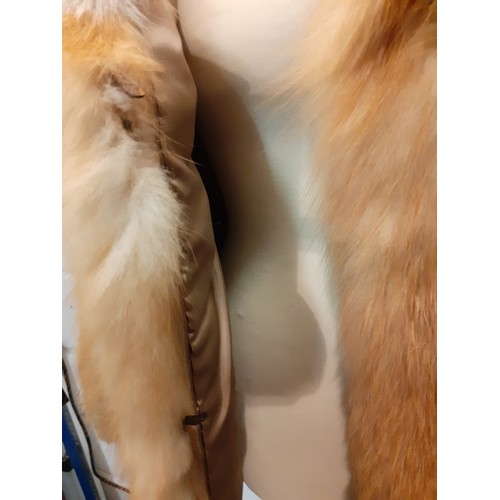 77 - A 1970's red fox fur jacket having vertical brown leather insertions, 2 front pockets and a shawl co... 