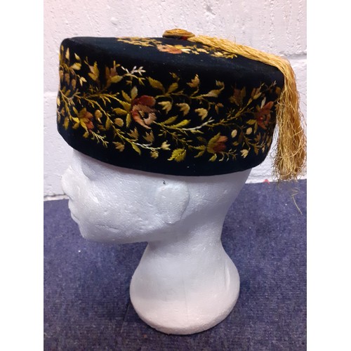 55 - A late 19th/early 20th Century hand-sewn black velvet smoking cap with yellow embroidered floral fri... 