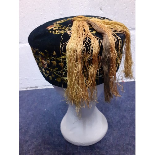 55 - A late 19th/early 20th Century hand-sewn black velvet smoking cap with yellow embroidered floral fri... 