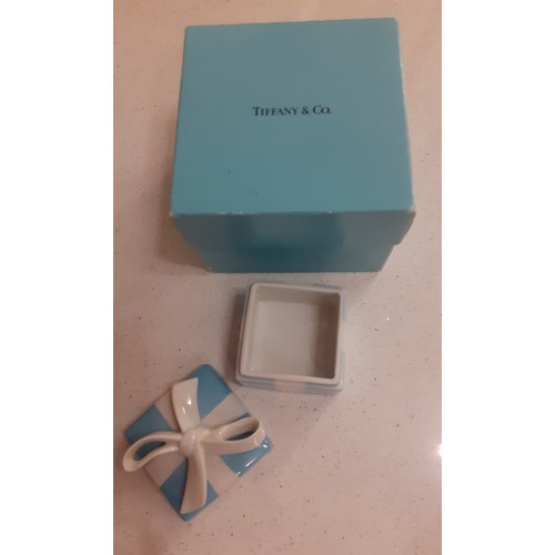 89 - Tiffany & Co- A ceramic box with ceramic bow to the lid, marked Tiffany to the base, together with b... 