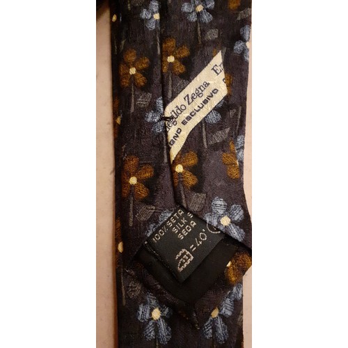 107 - Ermenegildo Zegna-Three silk ties in various colours and designs with original tie slip packets.
Loc... 