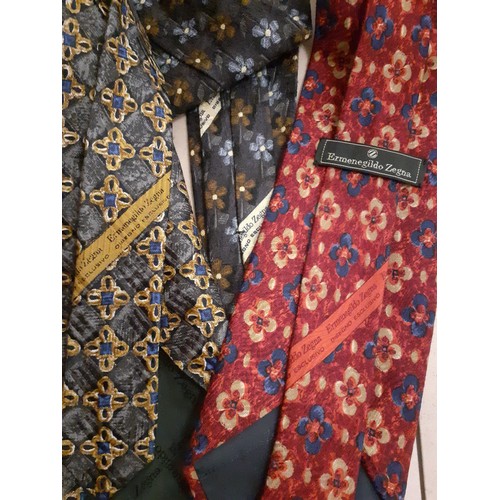 107 - Ermenegildo Zegna-Three silk ties in various colours and designs with original tie slip packets.
Loc... 