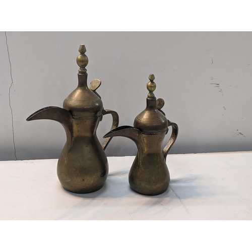 251 - Two Middle Eastern brass, possibly Ottoman Dallah coffee pots, marked to sides, tallest 30cm high
Lo... 