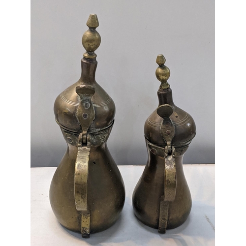 251 - Two Middle Eastern brass, possibly Ottoman Dallah coffee pots, marked to sides, tallest 30cm high
Lo... 