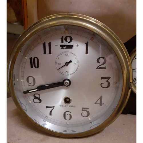 A ship wheel barometer in brass case, a ship's clock, a mid 20th