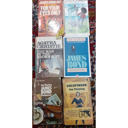 243 - Books-A small quantity of vintage paperback novels to include Agatha Christie and Ian Fleming. Locat... 