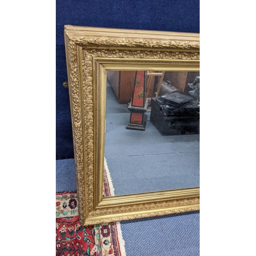 20 - A early 20th century carved gilt gesso picture frame, fitted with a mirror, 87.5cm h x 101.5cm w
Loc... 