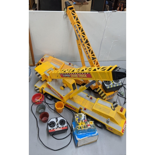 83 - A Tonka 3201 Super Crane Truck with operating remote, together with a similar one and other items
Lo... 