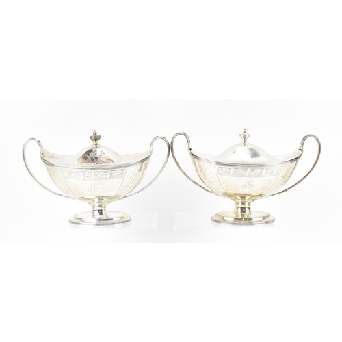 A pair of George III silver lidded sauce boats by John Robins, London 1795, with twin loop handles , the shaped lids with finials, engraved and stippled to the lid and body with monogram to the front, on an oval foot, 23 cm wide, combined weight 1143 grams
Location:T3