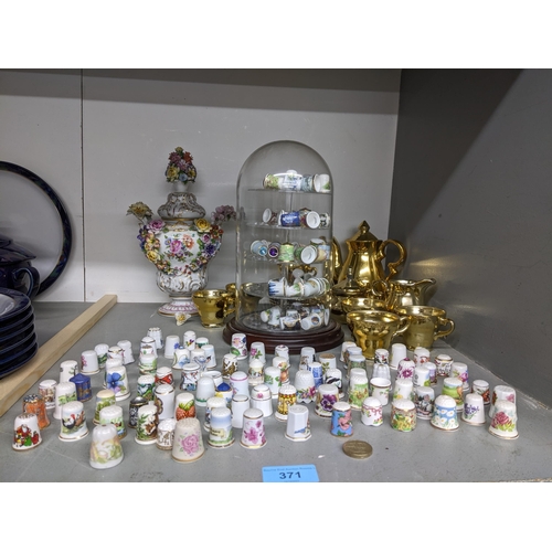 371 - A collection of porcelain thimbles some in domed display case, a Dresden style vase and cover decora... 