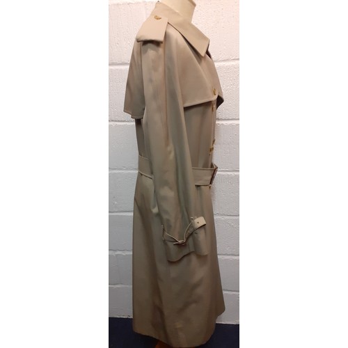 9A - Burberrys-A 1990's unisex beige double-breasted cotton-gaberdine trench coat long having a brown tar... 