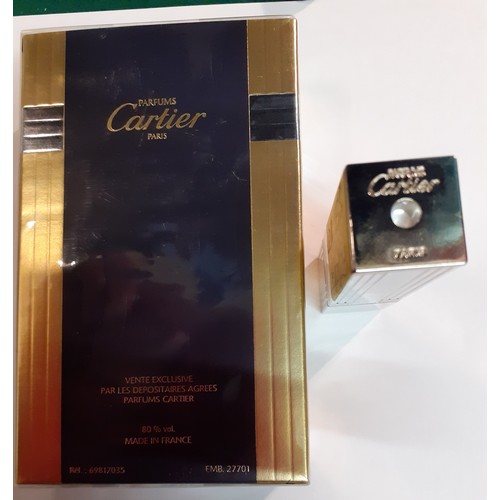 158 - Cartier- A 50ml Must De Cartier Eau de Toilette natural spray in sealed box together with a silver p... 