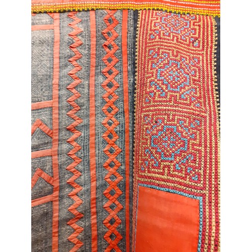 227 - A hand woven tribal blanket/throw/wall covering having sections of yellow, blue, pink and orange pat... 