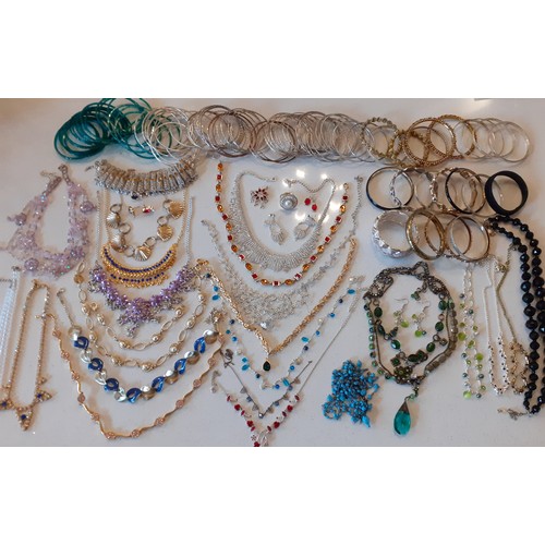 154 - A large quantity of modern costume jewellery, mainly Indian inspired bangles and gold tone necklaces... 