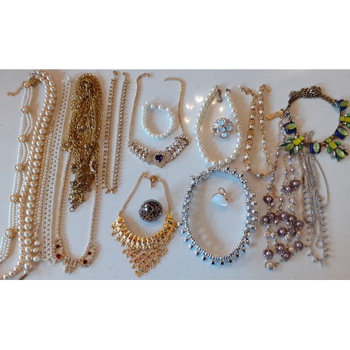 154 - A large quantity of modern costume jewellery, mainly Indian inspired bangles and gold tone necklaces... 