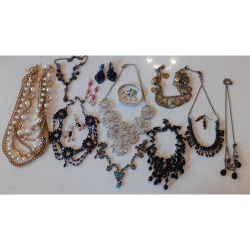 154 - A large quantity of modern costume jewellery, mainly Indian inspired bangles and gold tone necklaces... 