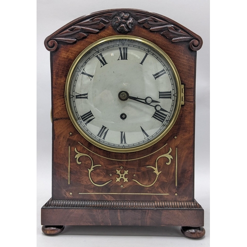 497 - A Regency mahogany bracket clock, the arched top case carved with scrolls, motif to the centre, bras... 