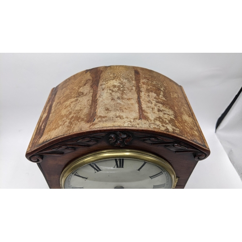 497 - A Regency mahogany bracket clock, the arched top case carved with scrolls, motif to the centre, bras... 