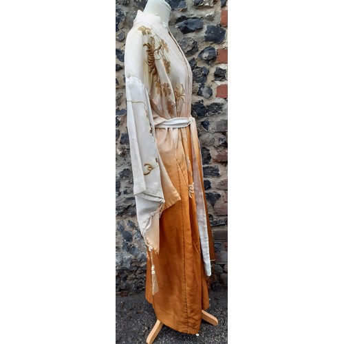 239 - An early 20th Century Japanese pale gold silk ground Kimono with sash belt and ombre effect to the m... 