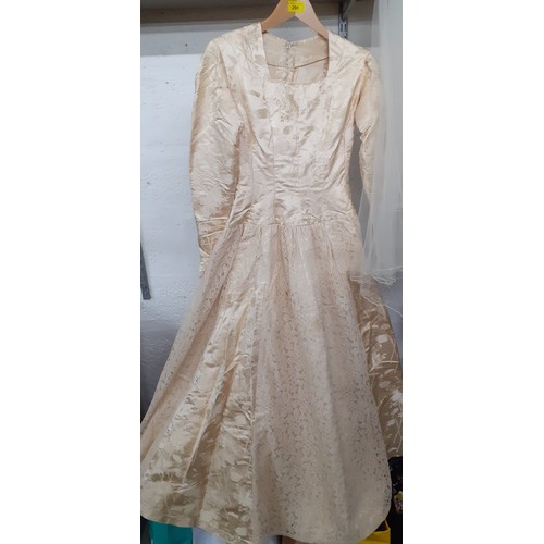 290 - A 1920's cream silk wedding dress A/F with machine embroidered floral design and button fastening to... 