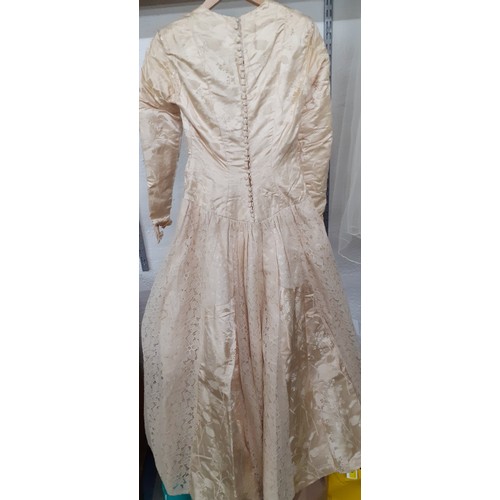 290 - A 1920's cream silk wedding dress A/F with machine embroidered floral design and button fastening to... 