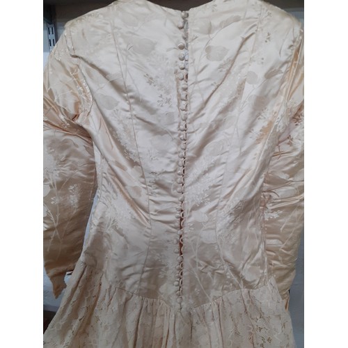 290 - A 1920's cream silk wedding dress A/F with machine embroidered floral design and button fastening to... 