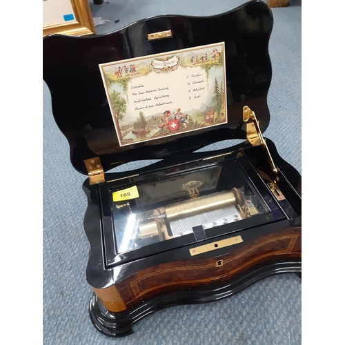 188 - A late 20th Century Reuge music box  in a walnut and mixed wooden case playing 4 songs. Location:RAB