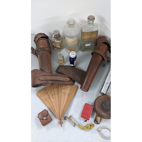 349 - A mixed lot to include a silver plated egg topper, a leather cased hunting flask, pharmacy bottles a... 