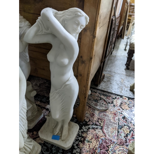 542 - A group of contemporary resin Parian ware style conservatory statues of three semi-clad maidens on s... 