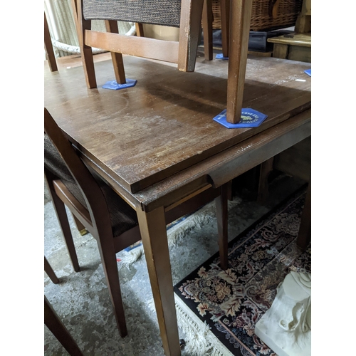 536 - A mid century teak extending dining table on square legs, 71.5cm x 84cm x 76cm (when extended) along... 