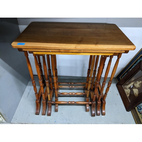 545 - A quartetto nest of walnut tables on turned legs and splayed feet united by turned stretchers 69.5x6... 