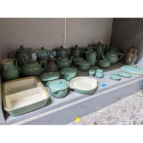 549 - A quantity of Denby green glazed table ware to include teapots, coffee pots, covered soup bowls and ... 