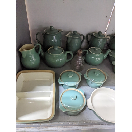 549 - A quantity of Denby green glazed table ware to include teapots, coffee pots, covered soup bowls and ... 